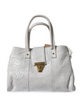 This white handbag is a leather piece featuring an intricate floral embossed design and a polished gold-tone clasp.