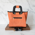 Bolsa naranja stand mármol